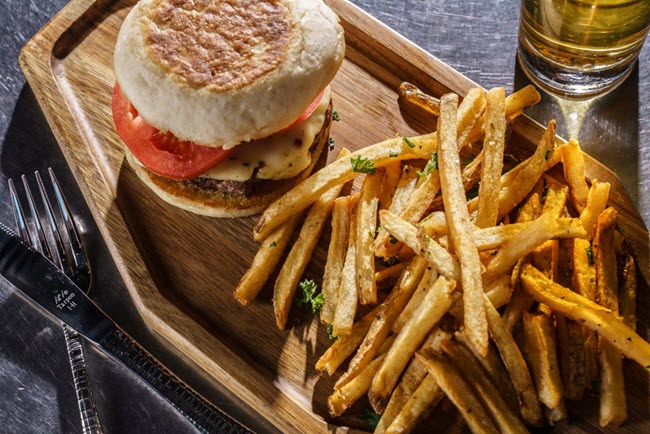 fries & burger on a wooden board